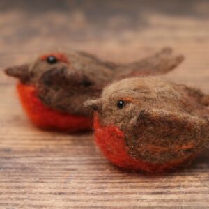 Image shows two needle felted robins