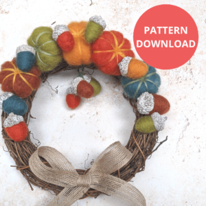 Image shows DIY autumn wreath with needle felted pumpkins and acorns