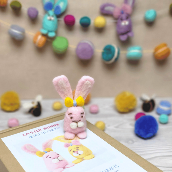 Needle felted Easter decorations including needle felted Easter bunny, bumble bees, and pom poms