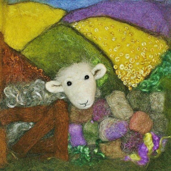 Image shows a needle felted sheep picture in lovely bright colours. A herdwick sheep is peering over a stone wall.