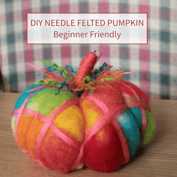 Colourful patchwork needle felted pumpkin against a checked background. Text reads: DIY Needle felted pumpkin beginner friendly